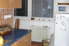 Pohled do kuchyně, rustikální dlažba a obklad za deskou