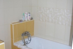 Detail obložení vany, sokl za vanou slouží jako odkladový prostor a zároveň přívod vody pro vanu